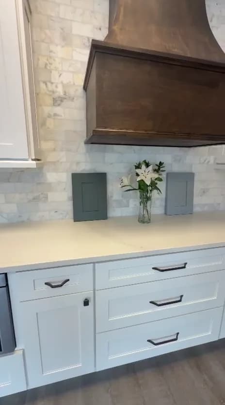Door samples on a white Shaker display beneath a stained wood hood